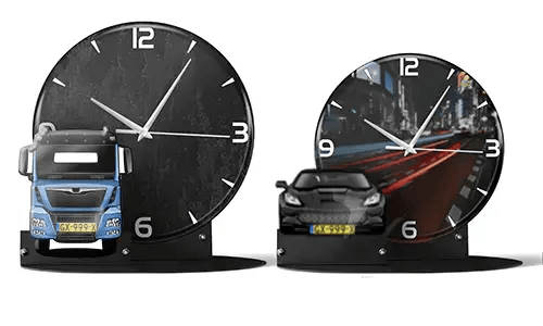Two decorative clocks with model vehicles: left with black marble face and blue truck, right with cityscape and red sports car