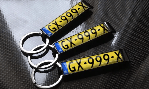 three bottle opener keychains with flags