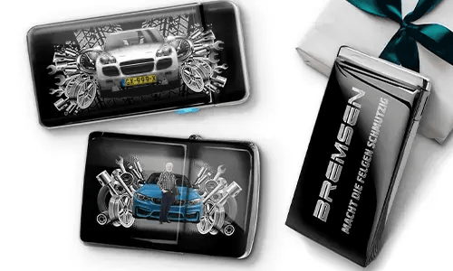 Three automotive-themed items featuring car illustrations and machinery motifs, arranged with a gift box tied with a green ribbon on the side.