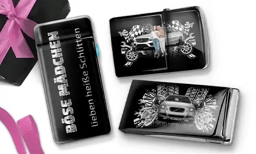 Three shiny black objects with car-themed designs. One reads 
