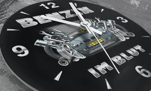 Wall clock with black sports car, pistons and wrenches, BENZIN IM BLUT text on black background