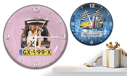 Two wall clocks with female figures and cars: left with trunk scene on pink texture, right with yellow sports car and racing flags over cityscape