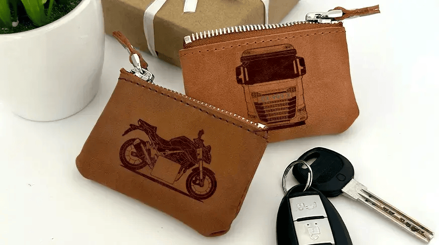 Two brown leather key pouches with zippers: one with motorcycle and plate 